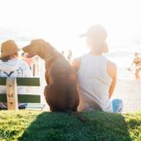 Sitting on a bench with his dog near the beach