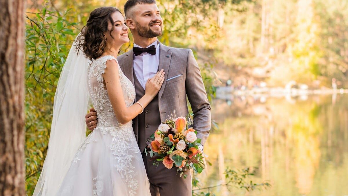 A man in a gray suit and a woman in a white wedding dress