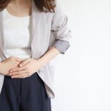 A woman holding her stomach