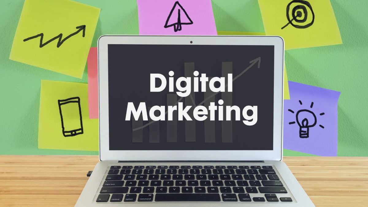 An image of a laptop displaying the words "Digital Marketing" on the screen, with colorful sticky notes and icons in the background, symbolizing marketing strategies and creative ideas.