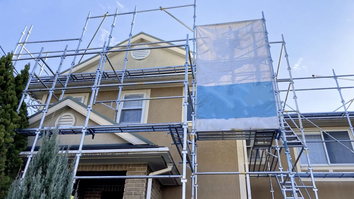 A house with scaffolding set up for exterior painting or repairs.