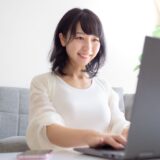 A woman working on a laptop, representing the idea of engaging in affiliate marketing.