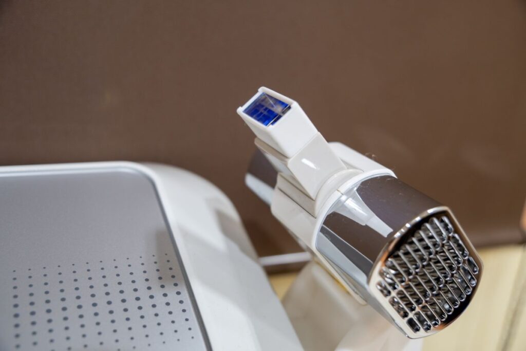 A close-up image of a laser hair removal device used in salons, representing the equipment for men’s VIO treatments.