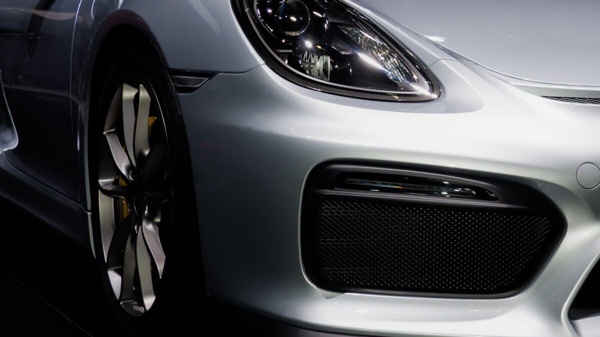 An image of a sports car’s front tire and bumper, representing the concept of an upgrade.