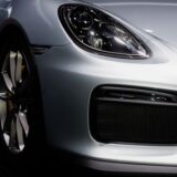 An image of a sports car’s front tire and bumper, representing the concept of an upgrade.